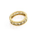 A Diamond Eternity Ring, the rose cut diamonds in white rubbed over settings, spaced by pierced