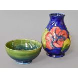 A Walter Moorcroft Pear Formed Vase, decorated with hibiscus on a cobalt ground, 13cm high, together