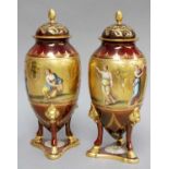 A Pair of 20th Century Vienna Style Porcelain Urns and Covers, of amphora form raised on three