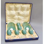 A Cased Royal Worcester Six Place Coffee Set, powder green ground and with gilt trailing borders,