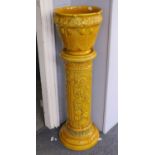 A Burmantofts Yellow Glazed Faience Jardiniere on Stand, moulded with sunflowers, jardiniere model