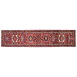 Narrow Heriz Runner North West Iran, circa 1960 The claret field with a column of cruciform and