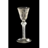 A Jacobite Wine Glass, circa 1750, the rounded funnel bowl engraved with a rose with single bud on a