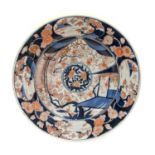 An Imari Porcelain Dish, Edo period, circa 1700, typically painted with a central roundel of flowers