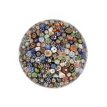 A Baccarat Close Millefiori Paperweight, circa 1847, with various silhouettes and other canes,