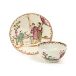 A Lowestoft Porcelain Tea Bowl and Saucer, circa 1780, painted in colours with chinoiserie figures
