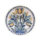 An English Delft Blue Dash Charger, probably Brislington, circa 1690, painted with tulips,