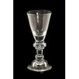 A Wine Glass, circa 1720, the funnel bowl on an annulated knop and plain stem with basal knop on a