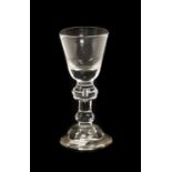 A Wine Glass, circa 1720, the funnel bowl on an annulated knop and plain stem with basal knop on a
