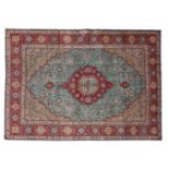 Tabriz CarpetNorth West Iran, circa 1950The aquamarine field centred by a stepped raspberry