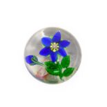 A Clichy Paperweight, circa 1850, worked with a blue flower and bud on a leafy stem6.5cm