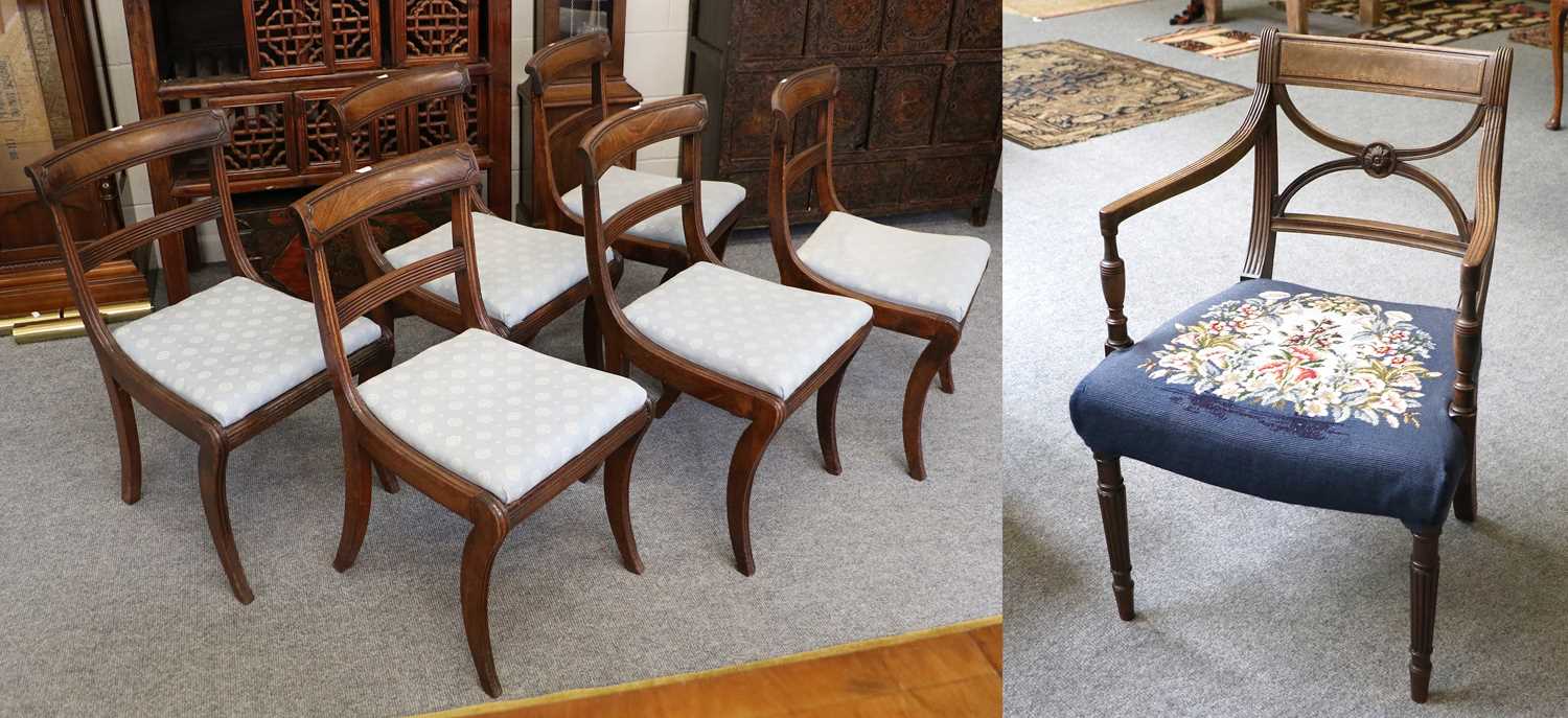 A Set of Six Regency Carved Mahogany Dining Chairs, with drop-in seats and raised on sabre supports;