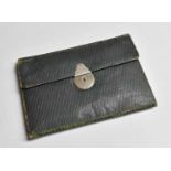 A Tooled Leather Wallet, early 20th century, with locking clasp and fitted interior22cm by 16cmTired