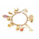 A Curb Link Bracelet, hung with ten various charms including a poodle, a pair of spectacles etc,