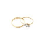 A 22 Carat Gold Band Ring, finger size N1/2; and A Diamond Three Stone Twist Ring, stamped '18CT'