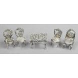 A Collection of Dutch or German Miniature Toy Silver Furniture, comprising four chairs, each with