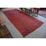 An Unusual Central Asian Rug, Khelleh, the crimson compartmentalised field of hooked guls,