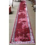 Hussainabad Runner of unusual length, circa 1960The raspberry Herati field enclosed by narrow