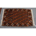 A Baluch Prayer Rug, the charcoal lattice field of heraldic devices, enclosed by borders of hooked