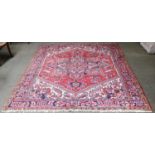 Heriz CarpetNorth West Iran, circa 1960The tomato red field of angular vines centred by a