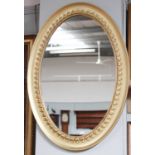 A Gilt Framed Oval Wall Mirror, bearing antique French trade label to the verso, 84cm by 59cm