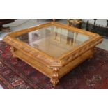 A Reproduction Hardwood Glass Top Coffee Table, the moulded top with a leaf-carved border, on