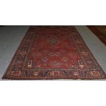 Joshaghan Carpet Central Iran, circa 1930 The brick red field of stylised plants around a...