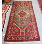 A Sarab Rug, the lozenge-shaped field with diamond medallion enclosed by ivory borders of