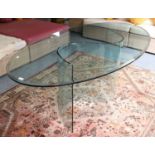 A Designer Glass Table, the oval top supported by an S-form glass base, 200cm by 105cm by 75cm
