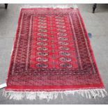 An Afghan Turkmen Rug, the claret field with columns of quarted guls enclosed by mulitple borders,
