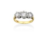 An 18 Carat Gold Diamond Three Stone Ringthe graduated round brilliant cut diamonds, in white claw