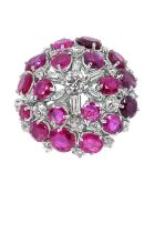 A Ruby and Diamond Cluster Ringthe central round brilliant cut diamond within a border of baguette
