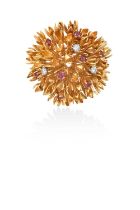 A Ruby and Diamond Brooch, by Tiffany & Co.in the form of a stylised flower, the yellow textured