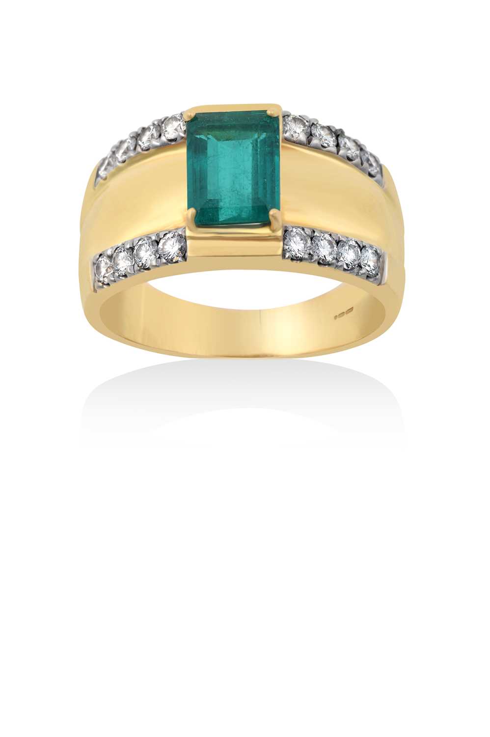 An 18 Carat Gold Emerald and Diamond Ringthe emerald-cut emerald in a yellow claw setting, to a