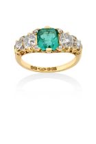 An Emerald and Diamond Five Stone Ringthe cushion shaped emerald flanked by graduated old cut