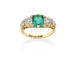 An Emerald and Diamond Five Stone Ringthe cushion shaped emerald flanked by graduated old cut