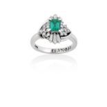 An Emerald and Diamond Cluster Ringthe emerald-cut emerald within a border of round brilliant cut