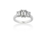A Diamond Three Stone Ringthe graduated emerald-cut diamonds in white claw settings, to a tapered