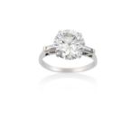 A Platinum Diamond Solitaire Ringthe round brilliant cut diamond in a four claw setting, to baguette