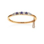 A Sapphire and Diamond Banglethree round cut sapphires in yellow claw settings alternate with old