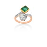 An Emerald and Diamond Crossover Ringa rectangular step cut emerald in a yellow millegrain setting