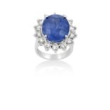 A Sapphire and Diamond Cluster Ringthe oval cut sapphire within a border of round brilliant cut