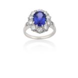 A Tanzanite and Diamond Cluster Ringthe oval cut tanzanite within a border of round brilliant cut