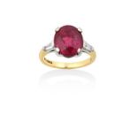 An 18 Carat Gold Ruby and Diamond Ringthe oval cut ruby flanked by tapered baguette cut diamonds, in