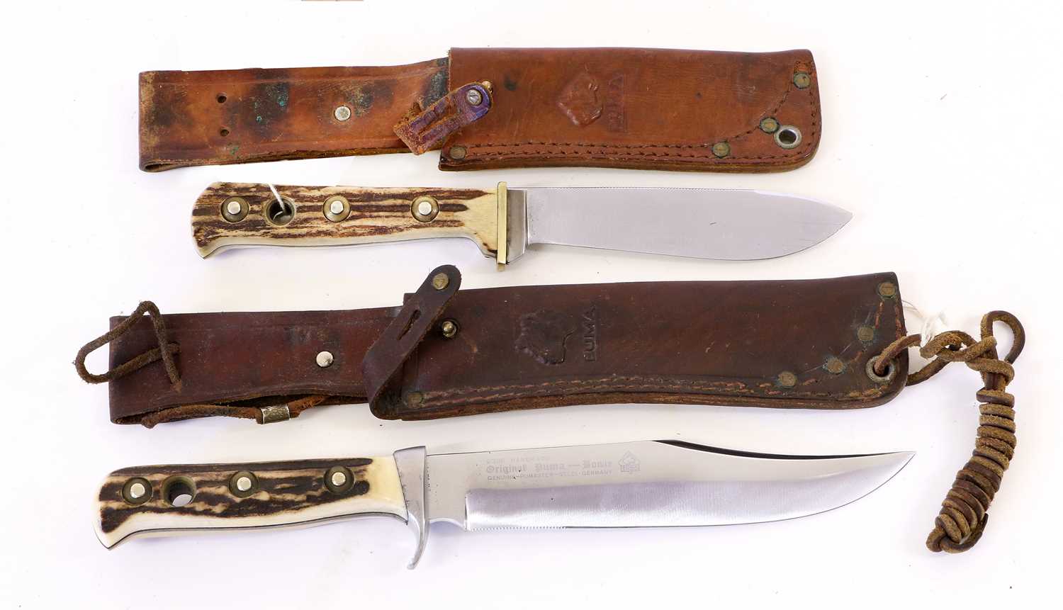 A German Puma Bowie Knife, the 16.5cm clip point steel blade with a 3cm serrated section, etched