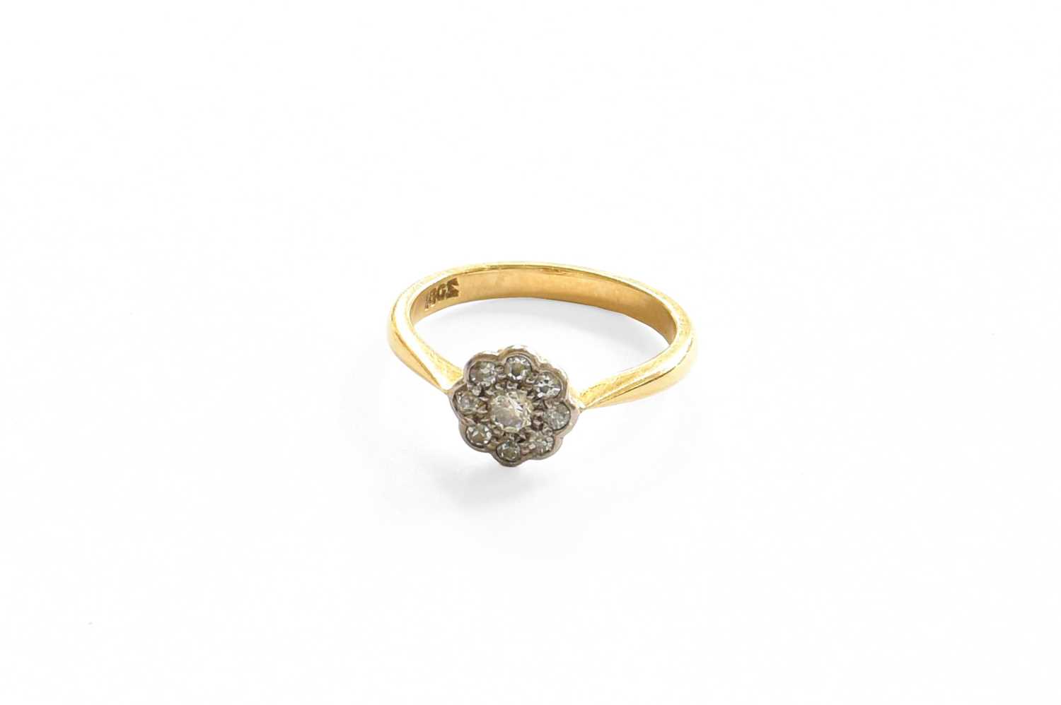 A Diamond Cluster Ring, stamped '18CT', finger size JThe ring is in good condition however one