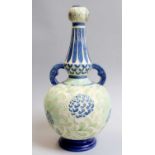 A Burmantofts Faience Twin-Handled Bottle Vase, shape number 2065, decorated with flowers, the