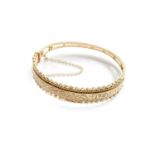 A 9 Carat Gold Hinged Bangle, inner measurements 5.8cm by 5.3cmGross weight 18.6 grams.
