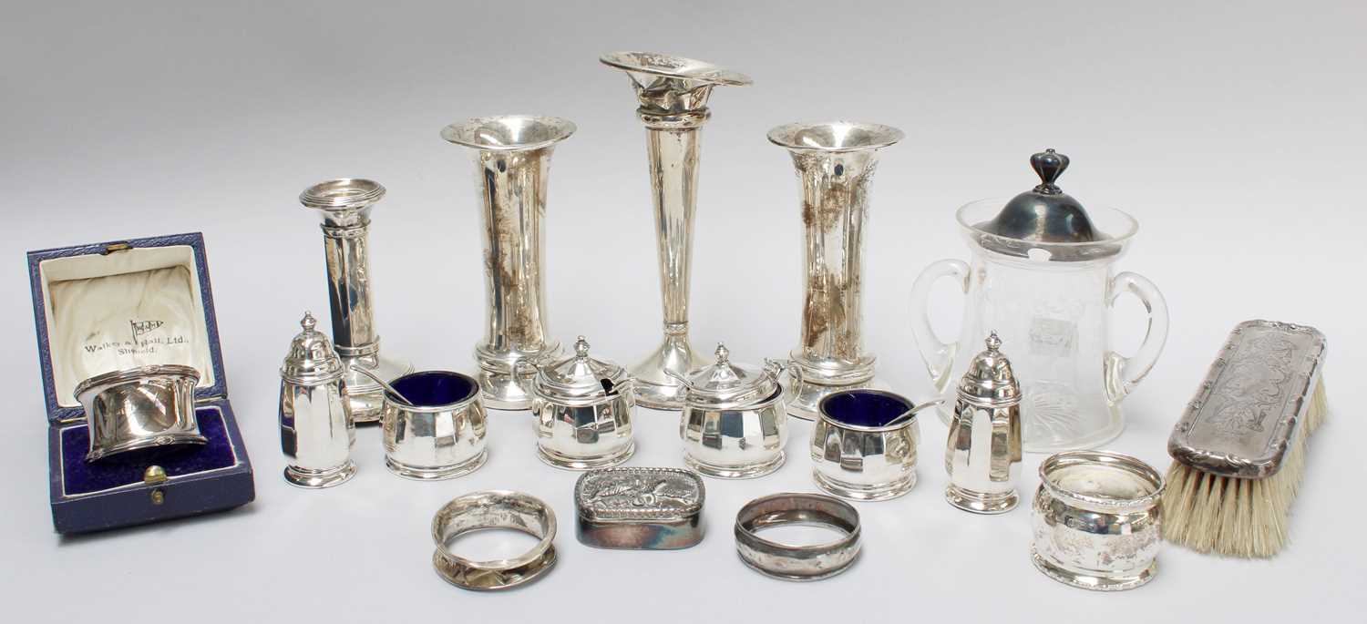 A Collection of Assorted Silver, to include: posy vases, mustard pots, a candle stick, napkin rings,