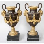 A Pair of Neo Classical Style Gilt Metal and Patinated Metal Twin Handled Urns, decorated with